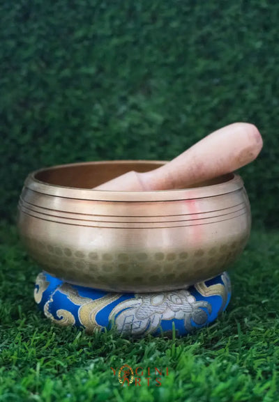 Invite mindfulness and calm with our handcrafted Dotted Buddha Singing Bowl. Featuring an engraved Buddha surrounded by a dotted mandala symbolizing stillness and spiritual balance, this bowl reminds you to stay present. Traditional mantras circle the rim, adding protection and spiritual energy. Handcrafted by skilled Himalayan artisans, it produces soothing tones that quiet the mind and support meditation, breathwork, and daily mindfulness practice.








