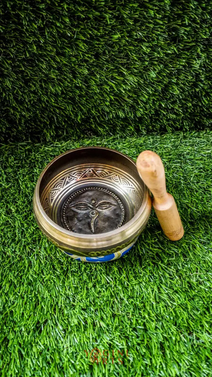 The Carved Buddha Eye Singing Bowl features the Buddha Eye symbol for spiritual clarity and protection. The Om Mani Padme Hum mantra circles the outside on mandala petals. Its clear, calming tones support meditation and mindfulness, bringing peace and focus to any space.