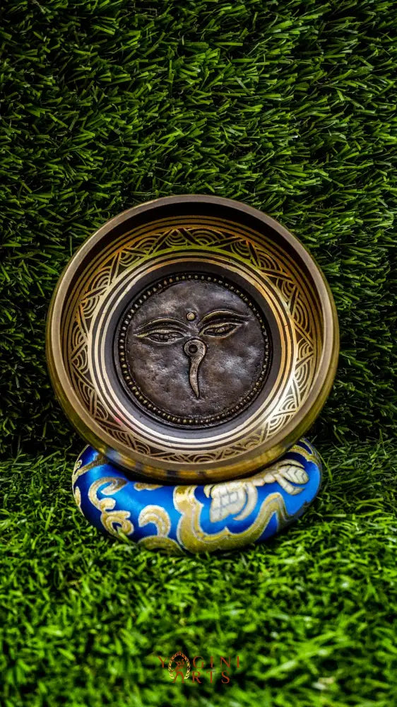 The Carved Buddha Eye Singing Bowl features the Buddha Eye symbol for spiritual clarity and protection. The Om Mani Padme Hum mantra circles the outside on mandala petals. Its clear, calming tones support meditation and mindfulness, bringing peace and focus to any space.