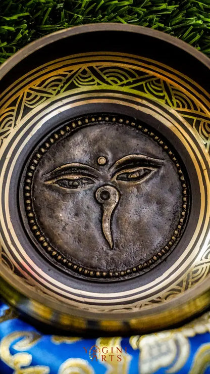 The Carved Buddha Eye Singing Bowl features the Buddha Eye symbol for spiritual clarity and protection. The Om Mani Padme Hum mantra circles the outside on mandala petals. Its clear, calming tones support meditation and mindfulness, bringing peace and focus to any space.