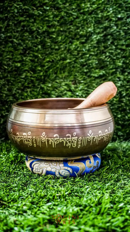 The Buddha Mandala Bronze Singing Bowl features a meditating Buddha inside a sacred mandala with the Om Mani Padme Hum mantra outside. Its soothing tones promote peace, focus, and spiritual balance and are perfect for meditation and grounding your space.