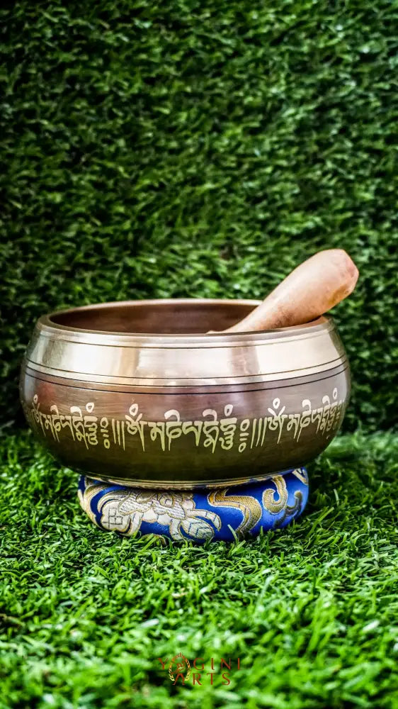 The Buddha Mandala Bronze Singing Bowl features a meditating Buddha inside a sacred mandala with the Om Mani Padme Hum mantra outside. Its soothing tones promote peace, focus, and spiritual balance and are perfect for meditation and grounding your space.