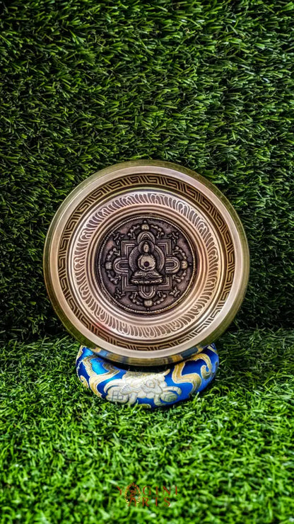 The Buddha Mandala Bronze Singing Bowl features a meditating Buddha inside a sacred mandala with the Om Mani Padme Hum mantra outside. Its soothing tones promote peace, focus, and spiritual balance and are perfect for meditation and grounding your space.