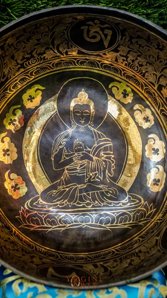 The Buddha Singing Bowl features a serene Buddha at the center surrounded by Om Mani Padme Hum syllables, with the full mantra on the outside. It produces a deep, steady tone that promotes calm, mindfulness, and inner peace. Perfect for meditation and reflection. Includes wooden mallet and silk cushion.