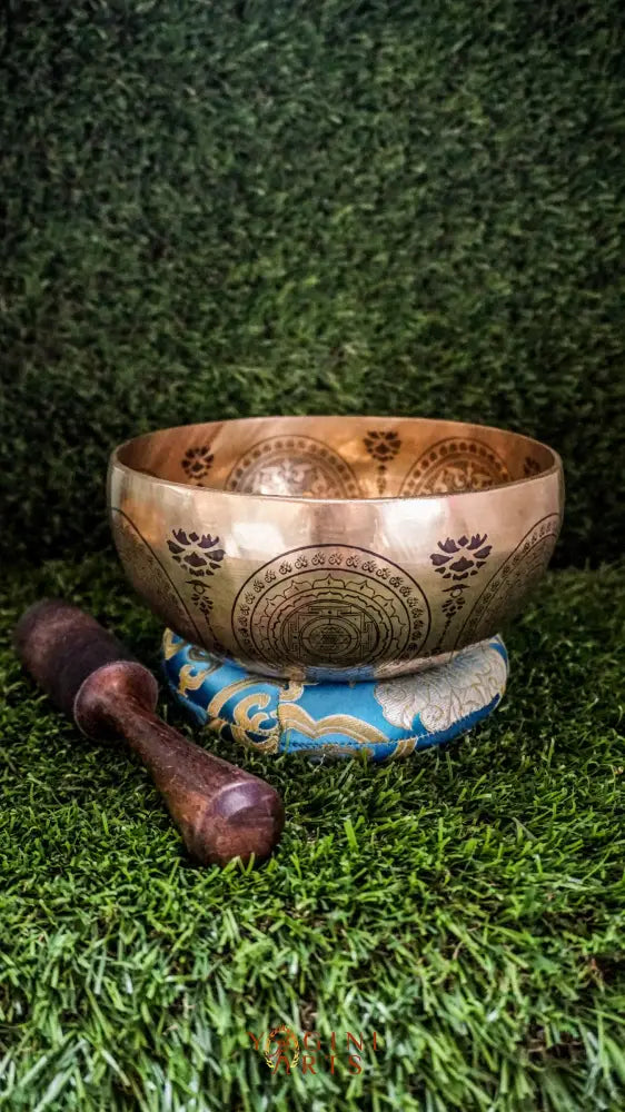Bring balance and harmony to your space with our handcrafted Flower Mandala Singing Bowl. Featuring a detailed flower mandala inside and symmetrical patterns outside, it symbolizes spiritual growth and unity. Each clear, soothing tone supports meditation, mindfulness, and emotional clarity. Handcrafted by skilled artisans, this bowl is perfect for your altar or on-the-go practice. Includes a wooden mallet and silk cushion for easy use and care.