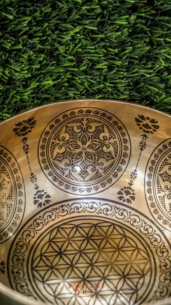 Bring balance and harmony to your space with our handcrafted Flower Mandala Singing Bowl. Featuring a detailed flower mandala inside and symmetrical patterns outside, it symbolizes spiritual growth and unity. Each clear, soothing tone supports meditation, mindfulness, and emotional clarity. Handcrafted by skilled artisans, this bowl is perfect for your altar or on-the-go practice. Includes a wooden mallet and silk cushion for easy use and care.