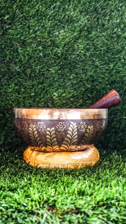 The Yin Yang Singing Bowl features the Yin Yang symbol inside a floral mandala with flower patterns outside. Its gentle sound brings calm and balance, perfect for meditation or peaceful spaces.