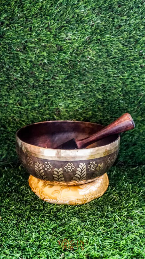 The Yin Yang Singing Bowl features the Yin Yang symbol inside a floral mandala with flower patterns outside. Its gentle sound brings calm and balance, perfect for meditation or peaceful spaces.