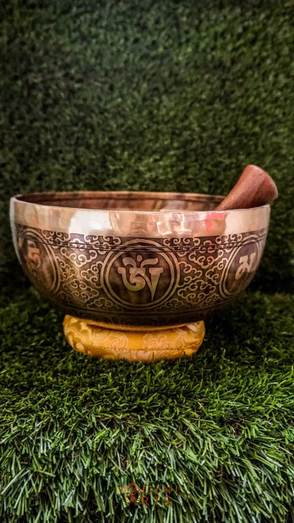 Invite compassion and healing into your space with our handcrafted Green Tara Singing Bowl. Featuring a detailed image of Green Tara inside, it symbolizes protection, care, and swift aid. The exterior is engraved with sacred patterns that amplify her blessings. Handmade by skilled artisans, this bowl produces clear, soothing tones that promote peace and focus. Includes a wooden mallet and silk cushion for easy use and care.