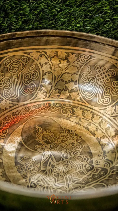 Invite compassion and healing into your space with our handcrafted Green Tara Singing Bowl. Featuring a detailed image of Green Tara inside, it symbolizes protection, care, and swift aid. The exterior is engraved with sacred patterns that amplify her blessings. Handmade by skilled artisans, this bowl produces clear, soothing tones that promote peace and focus. Includes a wooden mallet and silk cushion for easy use and care.