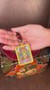 Hand-painted Zambala miniature Thangka pendant inside gold-accented copper Ghau locket with black and red beaded cord.