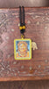 Hand-painted Zambala portrait miniature Thangka pendant in gold-accented copper Ghau locket with black beaded cord.