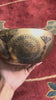Engraved Om Mani Padme Hum Mandala Singing Bowl displayed upright with a wooden mallet and blue cushion.