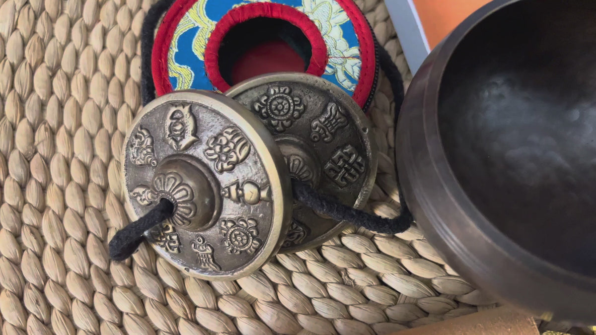 Buddhist ritual set from Nepal featuring singing bowl, Ashtamangala tingsha, wooden mallet, bell, vajra and meditation accessories
