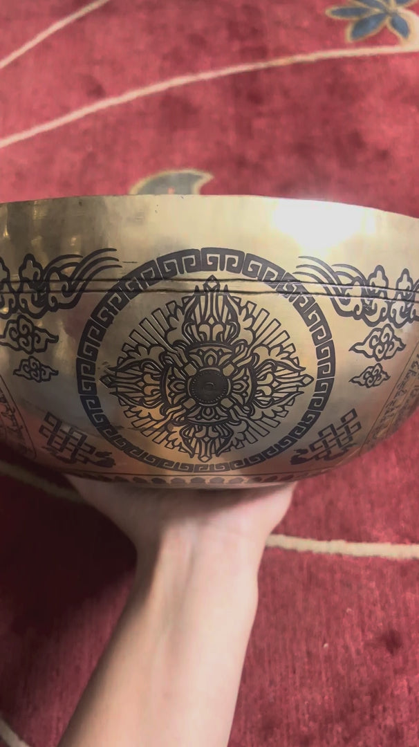 Interior view of Chengresi singing bowl featuring an engraved Bodhisattva, lotus throne, Tibetan mantras, and traditional Buddhist motifs