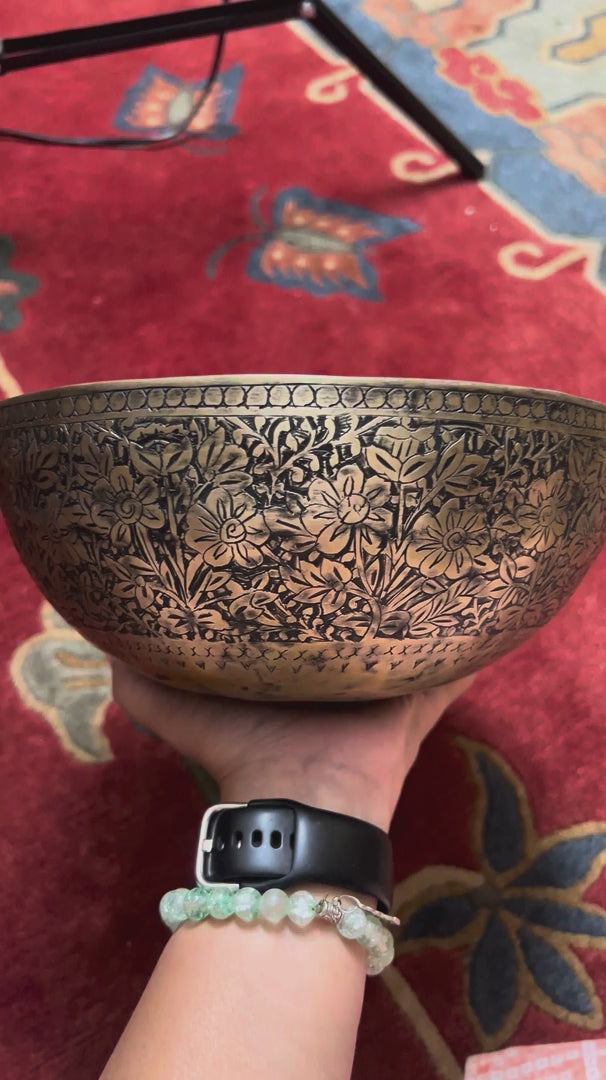 Semi antique floral engraved Tibetan singing bowl handcrafted in Nepal with detailed flower and foliage design