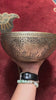 Semi antique singing bowl with hand-engraved bird and floral patterns, traditional Himalayan design