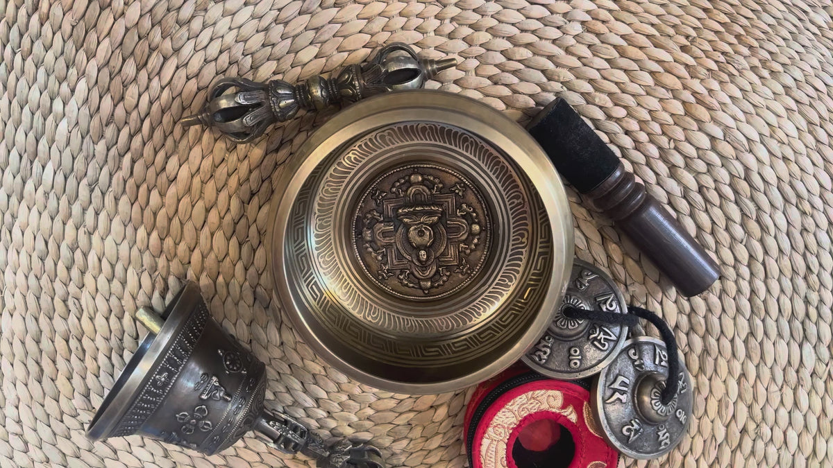 Load video: Handcrafted bronze Buddha singing bowl displayed with Buddhist ritual accessories