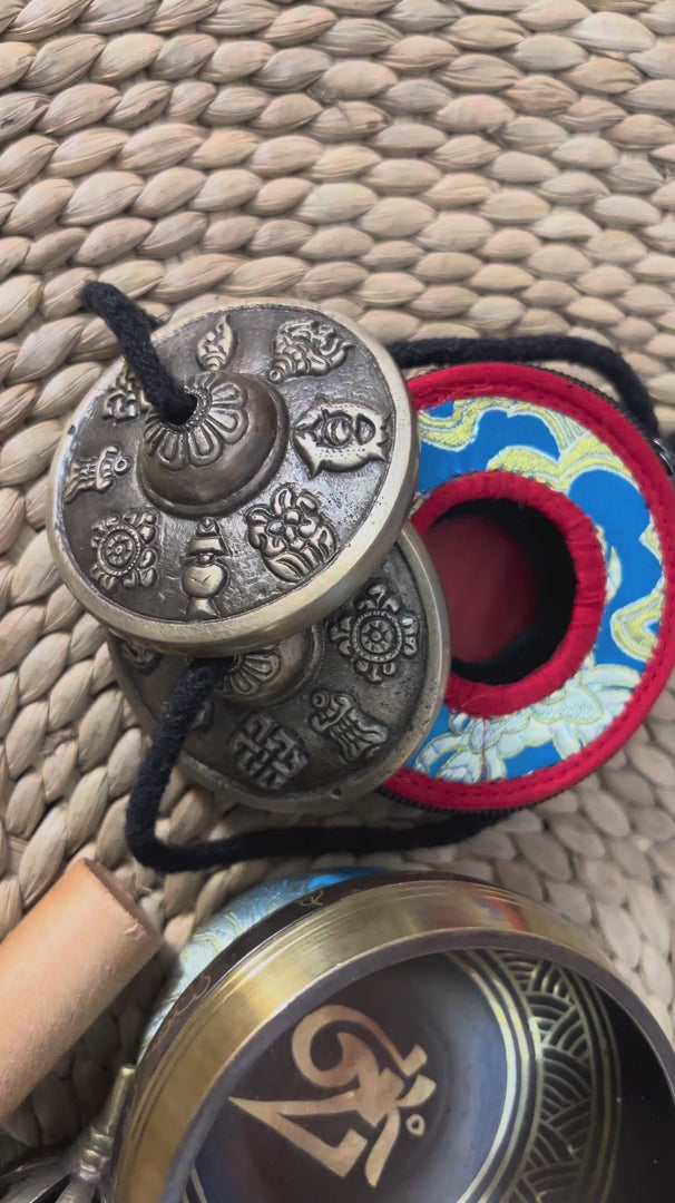 Mantra singing bowl meditation set with Ashtamangala tingsha, wooden mallet, cushion and Buddhist accessories from Nepal