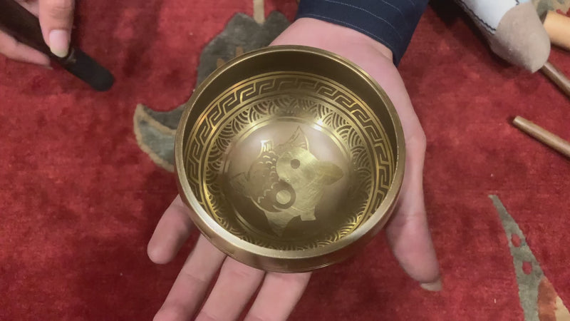 Yin Yang Fish Singing Bowl featuring two koi fish symbolizing balance and harmony. Wrapped in Om Mani Padme Hum mantra, it produces calming tones ideal for meditation and grounding.