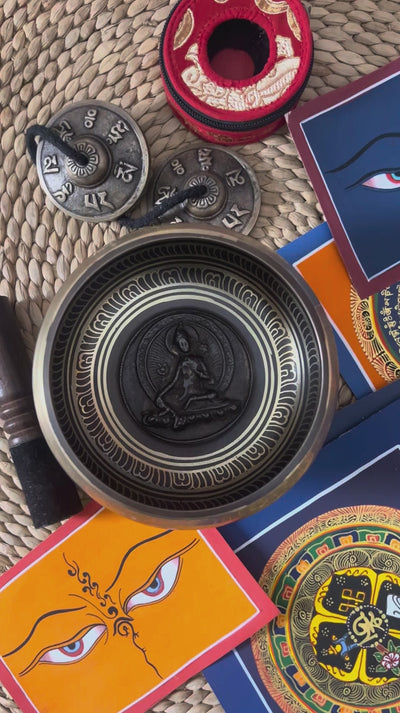 Handcrafted Green Tara bronze singing bowl with raised Buddhist figure and engraved interior