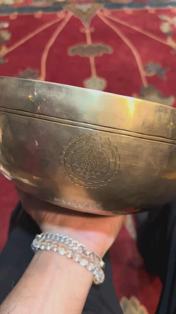 Interior of Chengresi singing bowl showing detailed engraved Buddhist artwork