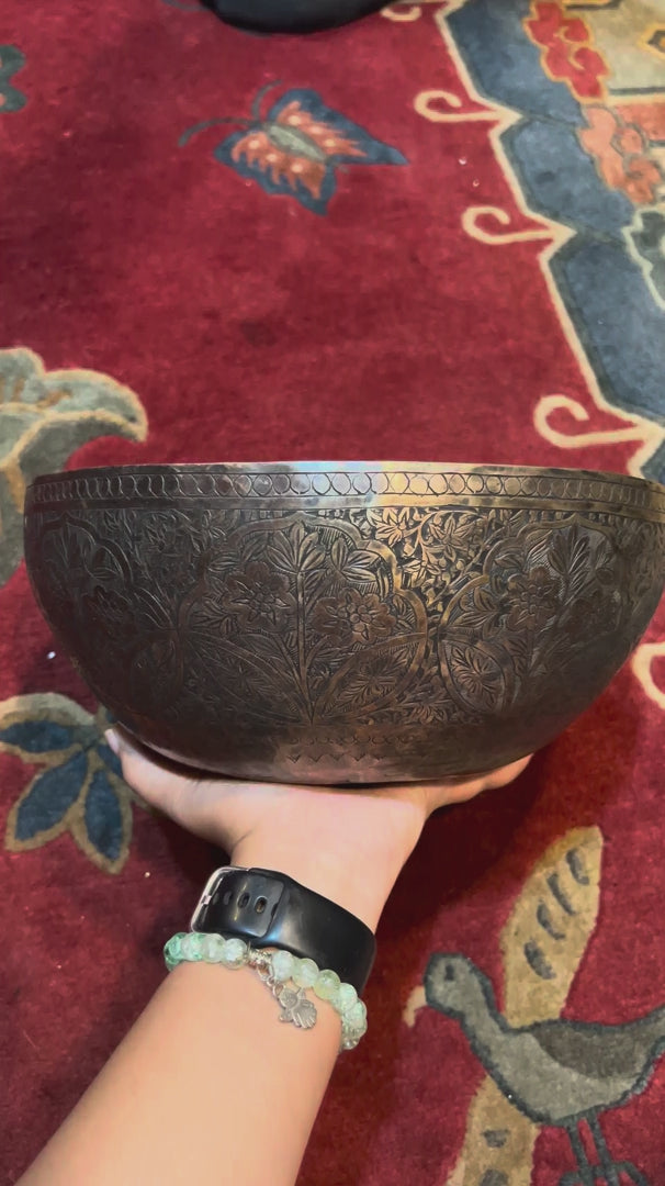 Semi antique floral engraved singing bowl handcrafted in Nepal with intricate flowers and leaf patterns in an antique bronze finish