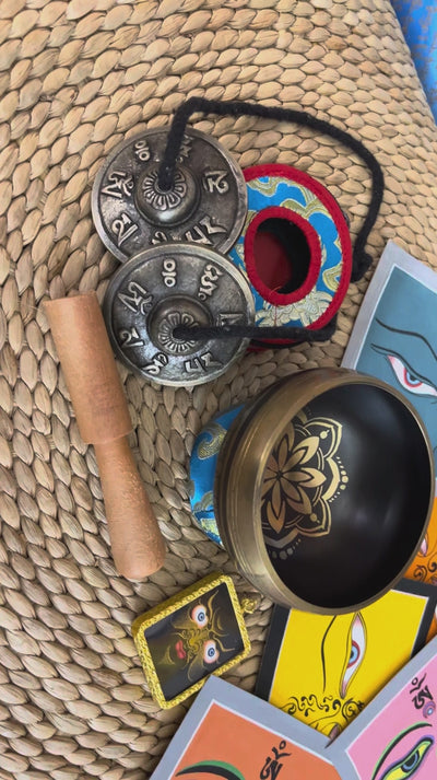 Ornate lotus singing bowl meditation set with Ashtamangala tingsha, wooden mallet, cushion and Buddhist devotional accessories from Nepal