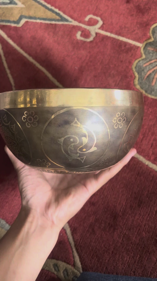 Load video: Golden Fish Symbol of Abundance Tibetan Singing Bowl with Engraved Twin Fish Motif