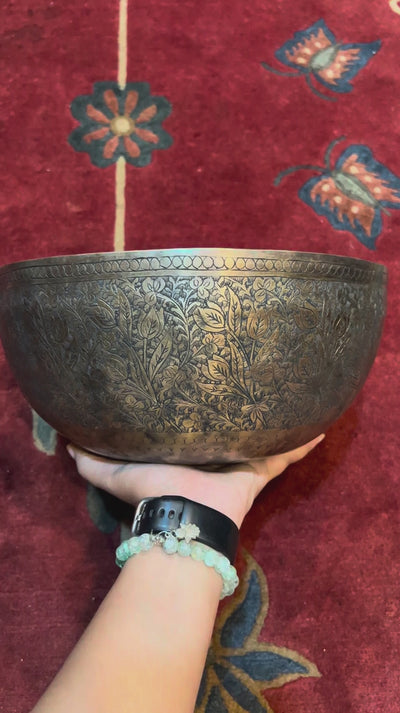 Semi antique singing bowl with intricate floral and leaf engraving, traditional Himalayan design