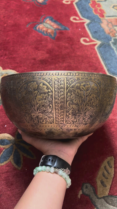 Semi antique handmade singing bowl with intricate floral panel engraving and aged bronze finish from Nepal