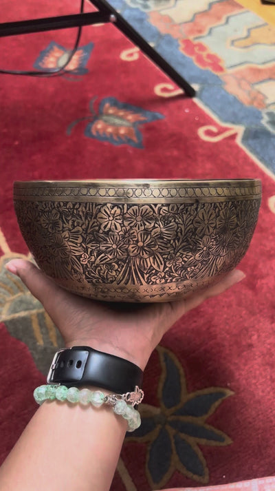 Semi antique handmade singing bowl with intricate floral engravings and aged bronze finish from Nepal