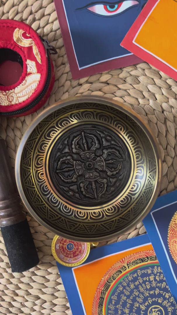 Load video: Dorje Singing Bowl Set with traditional Tibetan tingsha, suede mallet, decorative cushion, and Buddhist artwork from Nepal