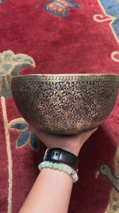Semi antique floral engraved singing bowl with intricate flower and leaf patterns and an antique bronze finish