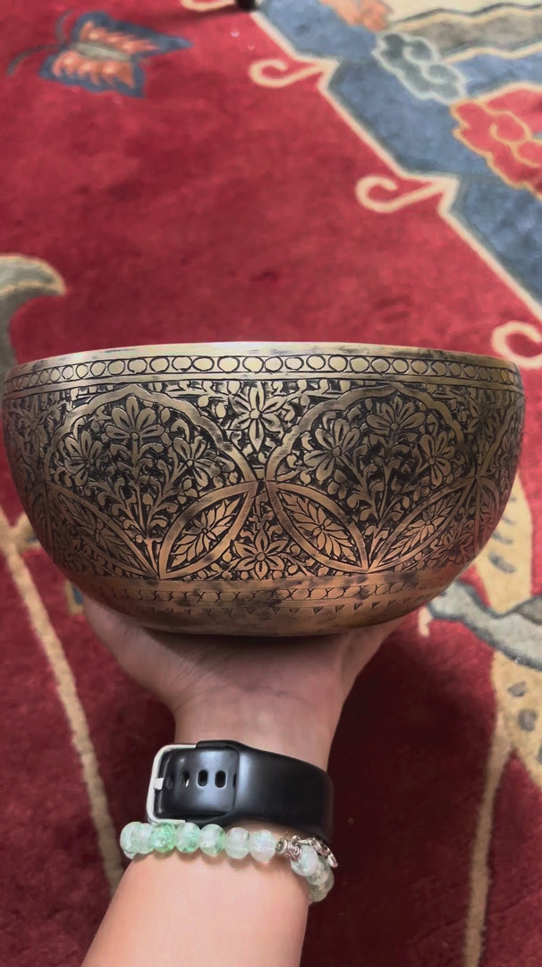 Semi antique floral engraved singing bowl handcrafted in Nepal with intricate flower and leaf patterns and an antique bronze finish