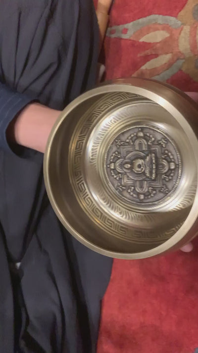 The Buddha Mandala Bronze Singing Bowl features a meditating Buddha inside a sacred mandala with the Om Mani Padme Hum mantra outside. Its soothing tones promote peace, focus, and spiritual balance and are perfect for meditation and grounding your space.