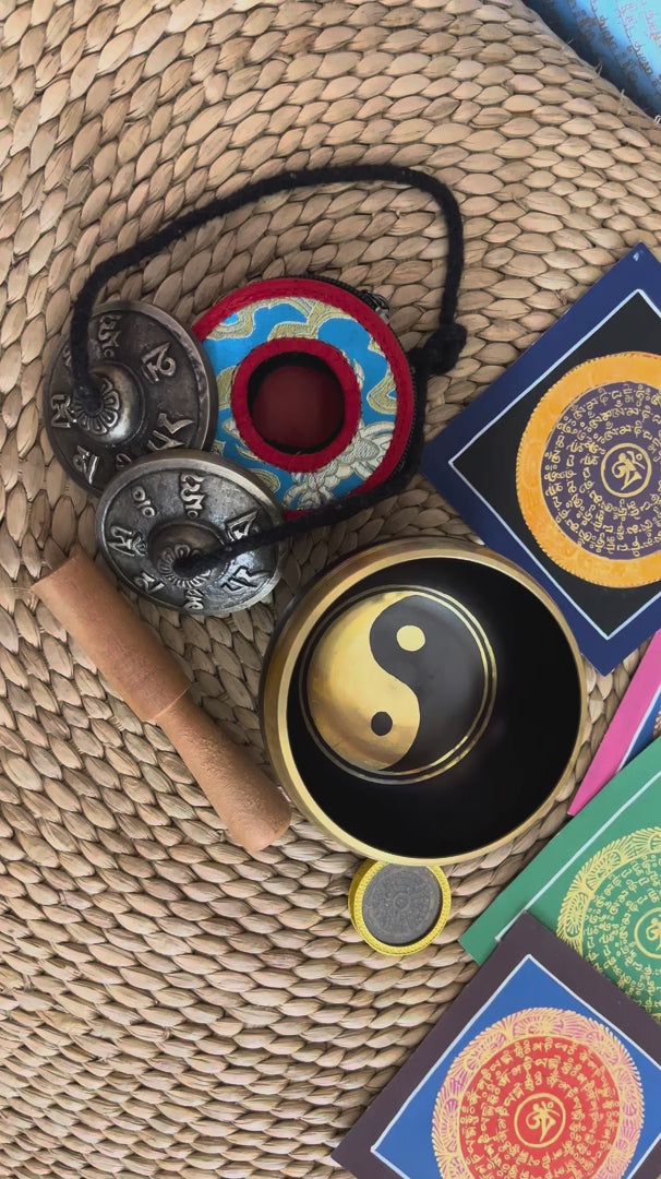 Yin Yang singing bowl meditation set with Ashtamangala tingsha, wooden mallet, cushion and Buddhist devotional accessories from Nepal