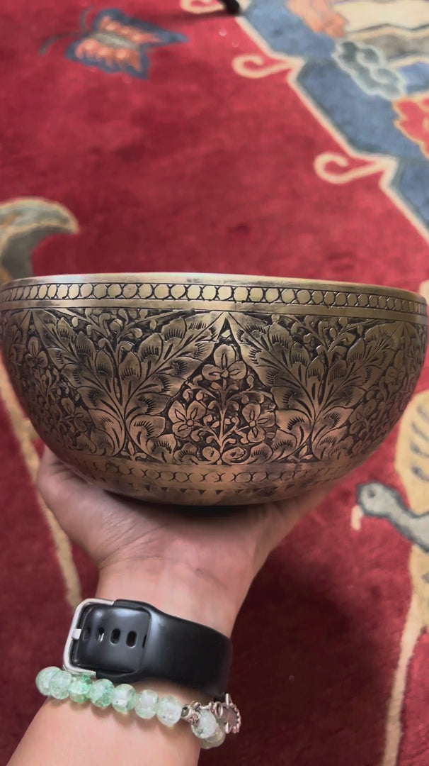 Semi antique Tibetan singing bowl with intricate floral engraving, handcrafted in Nepal for meditation and sound practice