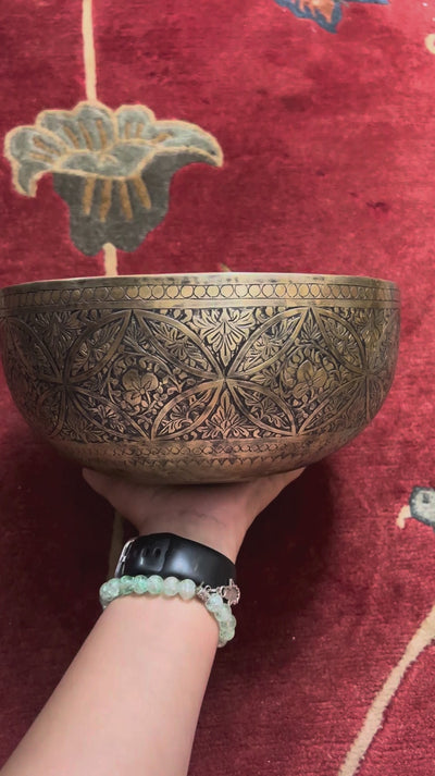 Semi antique handmade singing bowl with intricate geometric floral and leaf engraving on aged bronze metal