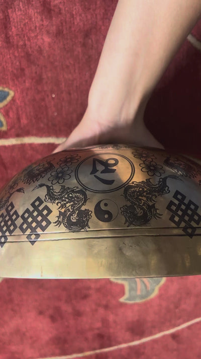 Green Tara singing bowl displaying engraved auspicious knots and traditional decorative motifs on the exterior